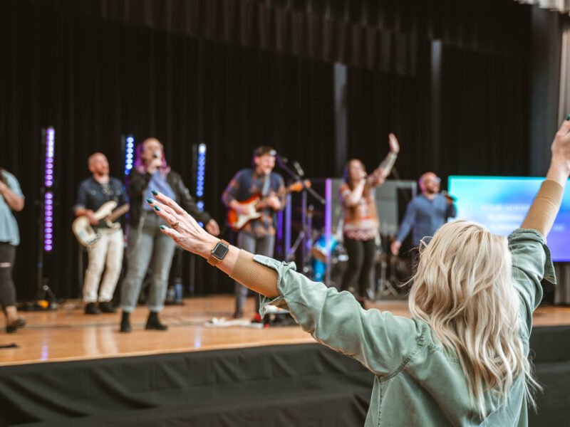 Rise Church Asheville Middle School worship service girl raised hands